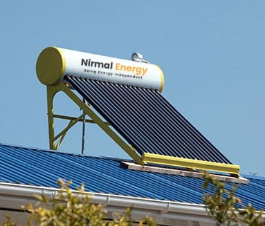 Evacuated-tube solar water heater installed on a blue metal roof